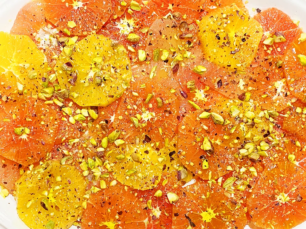 Sicilian style citrus salad with navel oranges, cara cara oranges, and blood oranges topped with pistachios