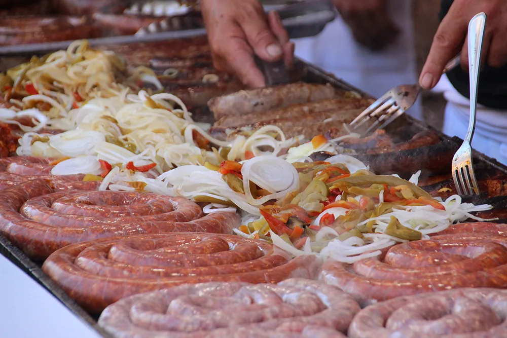 Sausage and peppers on the grill at a stand at the 2022 Giglio festival in Williamsburg Brooklyn